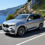 **

Prompt: A sleek, silver BMW X5 driving along a winding coastal road in Italy on a sunny day. The focus is on the car's sporty design and the beautiful Italian scenery. Emphasize the elegance and dynamism of the vehicle.

**